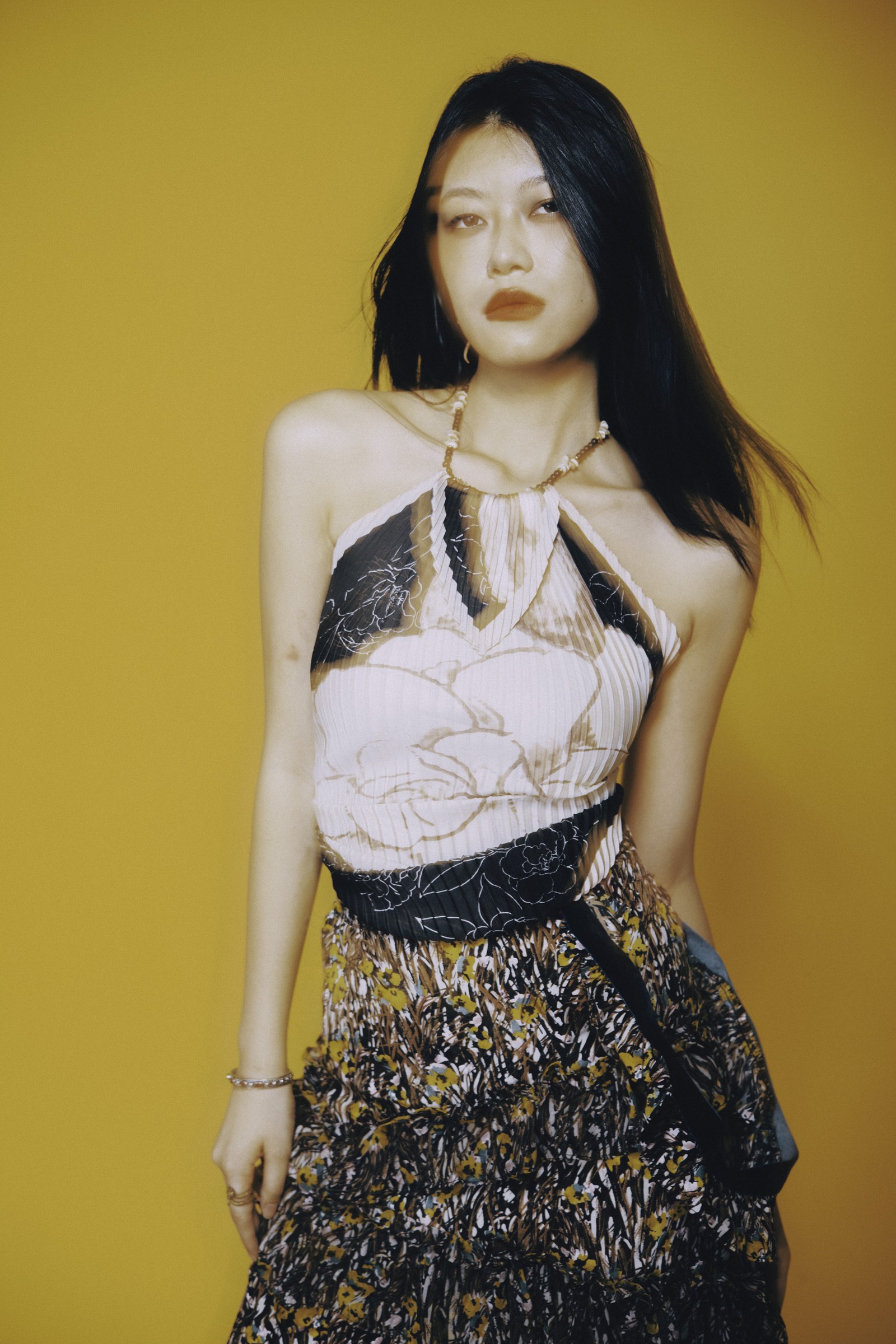 Model Emma against a mustard studio background by Eddie Huynh